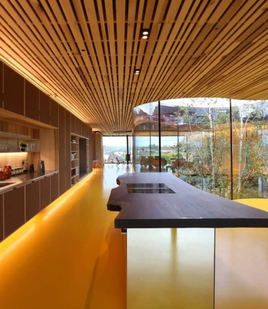 Modern kitchen with natural finishes and fire-safe materials, demonstrating the enhanced fire resistance of eco panels with compacted straw and protective plaster.