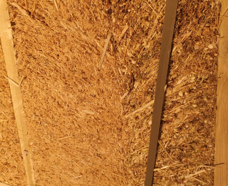 Close-up of compressed straw panel, a natural and breathable eco material that improves indoor air quality and supports healthy living.